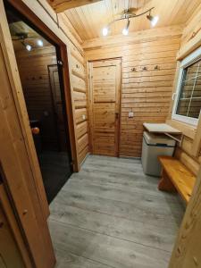a bathroom in a log cabin with a sink at Atokvėpis Alantos kaime in Alanta