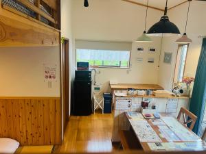a kitchen with a table and a refrigerator in it at Stay Nikko Guesthouse in Nikko