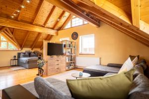 a living room with a couch and a tv at Ferienhaus Dobernik in Mühlbach