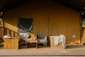 a stage with two chairs and a table on a stage at Butterfly Riverdale Yorkshire in West Tanfield