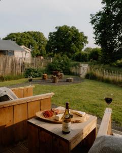 a bottle of wine and a plate of food on a table at Butterfly Riverdale Yorkshire in West Tanfield +3 photos