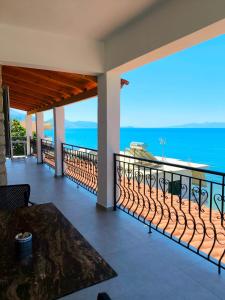a balcony with a view of the ocean at Petra Mare in Qeparo +9 photos