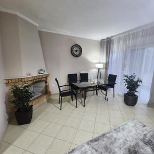 a living room with a table and a fireplace at Potamos Townhouse & Shared Garden in Potamós