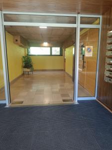 an empty hallway of an office building with a bench at Le 408 des pistes in La Bresse