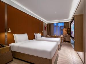 Voodi või voodid majutusasutuse Beijing Temple of Heaven Crystal Orange Hotel toas