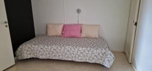 a bedroom with a bed with two pillows on it at Seurala Sorsakosken kylätalo in Sorsakoski