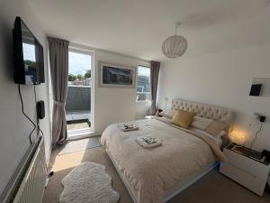a bedroom with a large bed and a television at Jeans Place Watergate St Rows near racecourse in Chester