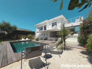 a house with a swimming pool in front of it at VILLA EVE Bord de plage spa piscine roof top in Andernos-les-Bains +53 photos
