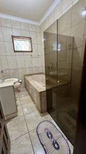 ein Badezimmer mit Dusche, Badewanne und Waschbecken in der Unterkunft Área de Lazer Sertãozinho in Sertãozinho + 10 Fotos