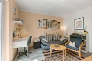 a living room with a couch and a piano at Ferienwohnung Sonnenblick in Bad Berleburg