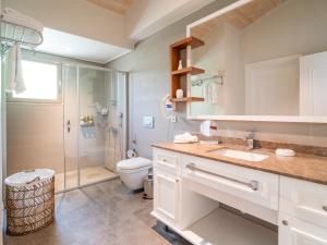 a bathroom with a shower and a toilet and a sink at Kimera Lounge Hotel in Cıralı +79 photos