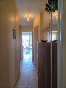 a hallway leading to a kitchen with a refrigerator at Appartement terrasse, piscines, wi-fi, résidence face mer in Les Sables-dʼOlonne