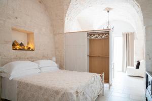 Postel nebo postele na pokoji v ubytování Apulian Charme Trulli and Cottage
