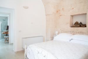 Postel nebo postele na pokoji v ubytování Apulian Charme Trulli and Cottage