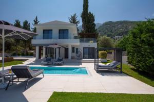 a villa with a swimming pool and a house at Elysian villas in Palaiokatoúna