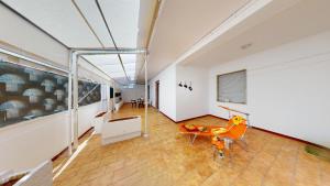 an empty room with a table and chairs in a building at CIAK House in Maglie