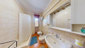 a white bathroom with a sink and a toilet at CIAK House in Maglie +11 photos