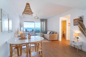 a living room with a table and a couch at Luxury Rooftop Isea 1132 by Casasol in Torrox Costa