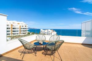 a balcony with a table and two chairs and the ocean at Luxury Rooftop Isea 1132 by Casasol in Torrox Costa