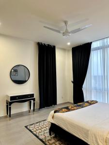 a bedroom with a bed and a desk and a tv at 2 BHK Apartment in ISLAMABAD in Islamabad +4 photos