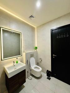 a bathroom with a toilet and a sink at 2 BHK Apartment in ISLAMABAD in Islamabad