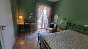 a bedroom with a bed and a desk and a window at Villa MaVi Guesthouse in Maenza