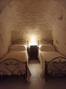 Postel nebo postele na pokoji v ubytování Apulian Charme Trulli and Cottage