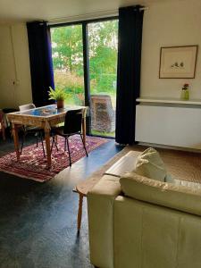 a living room with a couch and a table at Natuurhuis Marke Lemselo 80 m2 in Weerselo