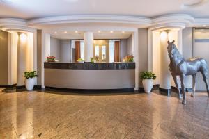 a statue of a horse in the lobby of a hotel at Hotel Plaza in Duisburg