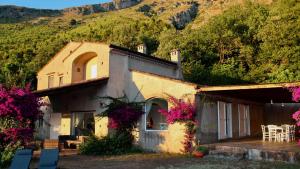 a house with flowers on the side of it at San Biagio Lodges Maratea in Cersuta in Maratea
