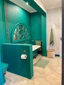 a green bathroom with a tub and a sink at Underberg - The Burn - Solar Powered in Underberg +45 photos