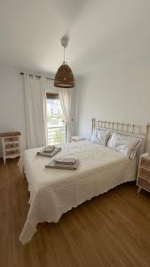 En eller flere senge i et værelse på BS House Praia da Lota - Casa do Mar