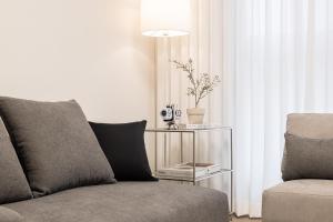 a living room with a couch and a table with a lamp at Stylish Modern Condo, 3 Bedrooms, 2 Bathrooms, 4 Air Conditioners, 65-inch TV, Laundry Machine & Dryer in Seoul +65 photos