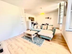 a living room with a couch and a table at Le Provençal Colline St Jacques in Cavaillon
