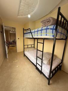 two bunk beds in a room with a hallway at Berber vibes in Tamraght Ouzdar