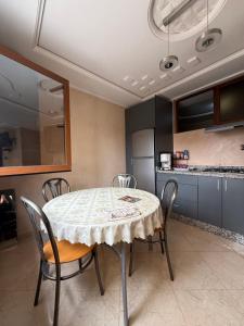 a dining room with a table and chairs in a kitchen at Berber vibes in Tamraght Ouzdar