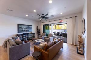 a living room with couches and a ceiling fan at Desert Haven near Zion with Pool and Hot Tub in Hurricane