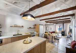 an open kitchen and dining room with a dining table at Anyfantata in Sívros