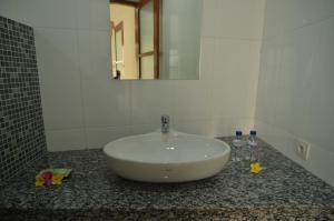 a white sink in a bathroom with a mirror at Villa Ngetis in Sanur +19 photos