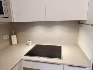 a kitchen with white cabinets and a sink at Apartamento EGUZKILORE Izaba-Isaba in Isaba +10 photos
