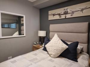 Ένα ή περισσότερα κρεβάτια σε δωμάτιο στο At Leisure Apartment 2