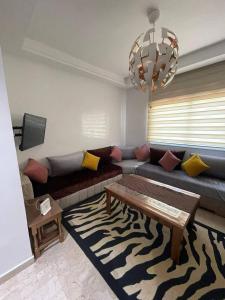 a living room with a couch and a table at Salam Beach in Pont Blondin