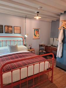 a bedroom with a large bed in a room at Grain Store Cottage in Narberth