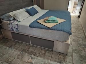 a bed with a blanket and a towel on it at Portal La Delfina in Ciudad Lujan de Cuyo +17 photos