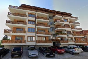 a large building with cars parked in front of it at Katerina Apartments 2 in Velingrad