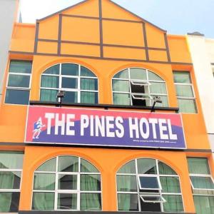 an orange building with a sign that reads the pines hotel at The Pines Hotel in Tanah Rata