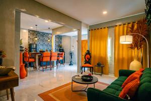 a living room with a green couch and a table at Amshiga 5 in Jimbaran