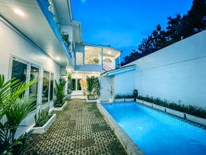 a swimming pool in the backyard of a house at Amshiga 5 in Jimbaran