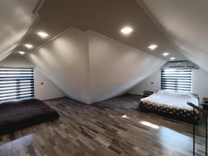 a room with two beds and a large wall at Praqa House in Lankaran