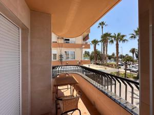 a balcony with a table and chairs on a building at A&N Seafront 2 Torre del Mar in Torre del Mar